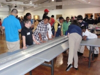 Students making last minute adjustments before the Magnetic Levitation races